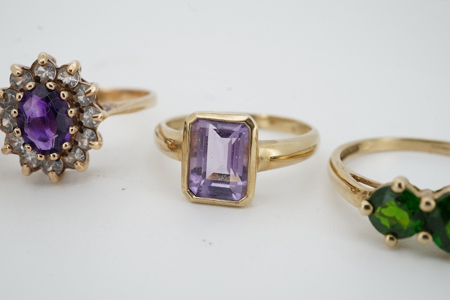 Five gem-set rings, comprising: three rings set with peridots and, one ring set with an amethyst, and one designed as a cluster of amethyst and rock crystal, each mounted in 9ct gold, sizes N-U, each with British hallmar